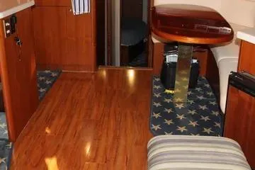 Slide: The Image of Interior of a 1996 Ocean 53 Super Sport yacht with wooden flooring and star-patterned carpet. - 9