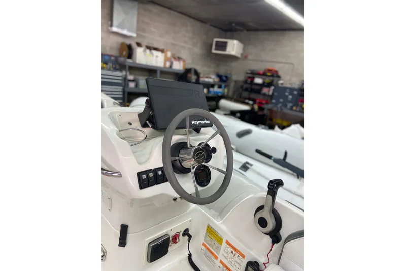 Slide: The Image of Steering console of 2011 Walker Bay Generation 390 boat in a workshop setting. - 3