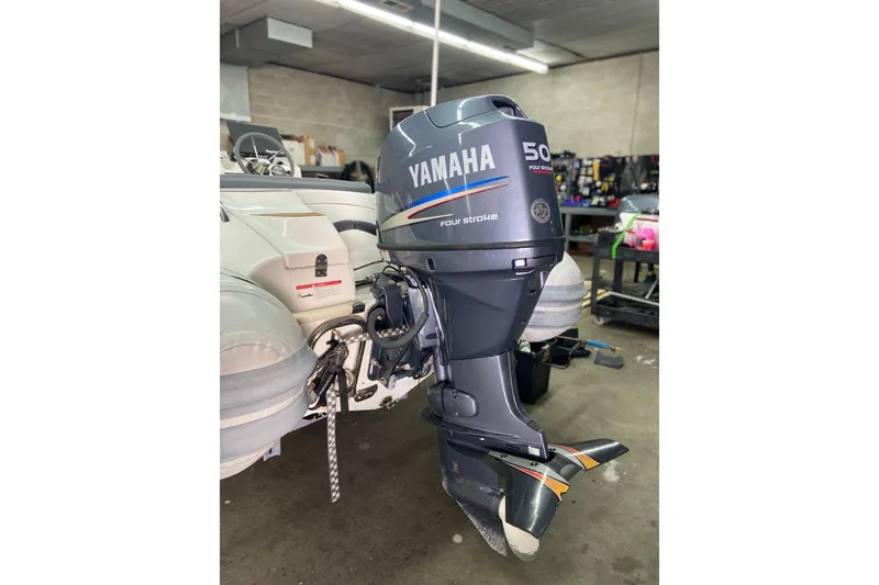 Slide: The Image of Walker Bay Generation 390 boat with Yamaha 50HP outboard motor in a garage setting. - 4