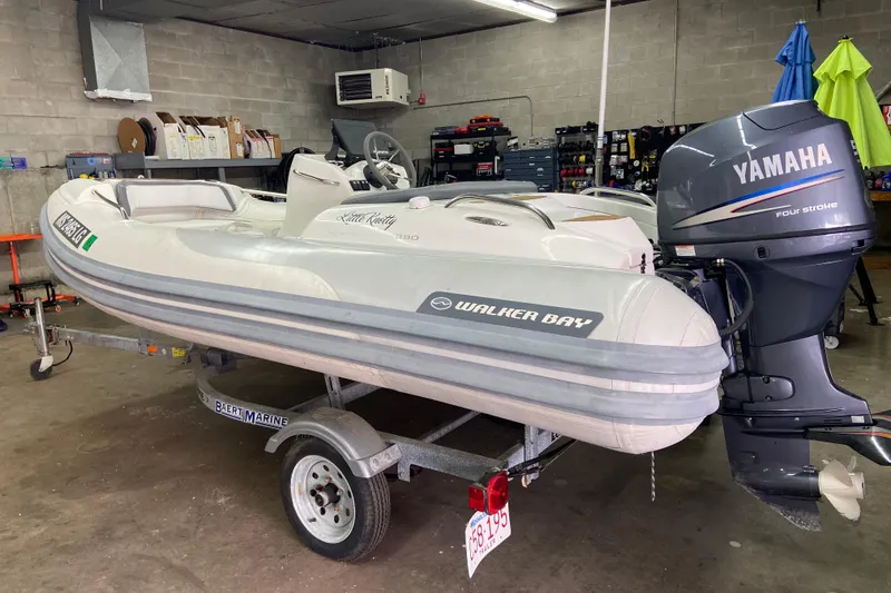 Slide: The Image of 2011 Walker Bay Generation 390 inflatable boat with Yamaha four-stroke engine in a garage. - 7