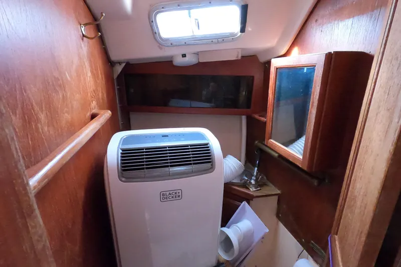 Slide: The Image of Interior of a 1978 Catalina 30 sailboat with portable air conditioner. - 11