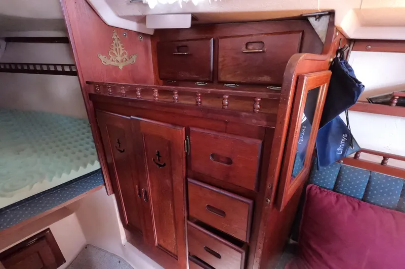 Slide: The Image of Interior of a 1978 Catalina 30 sailboat with wooden cabinetry and storage. - 12