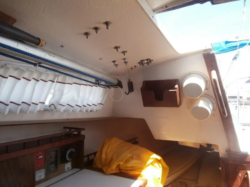 Slide: The Image of Interior of a 1978 Catalina 30 sailboat with storage and seating area. - 13