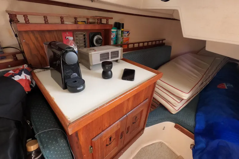 Slide: The Image of Interior of a 1978 Catalina 30 sailboat with coffee maker and cushions. - 17