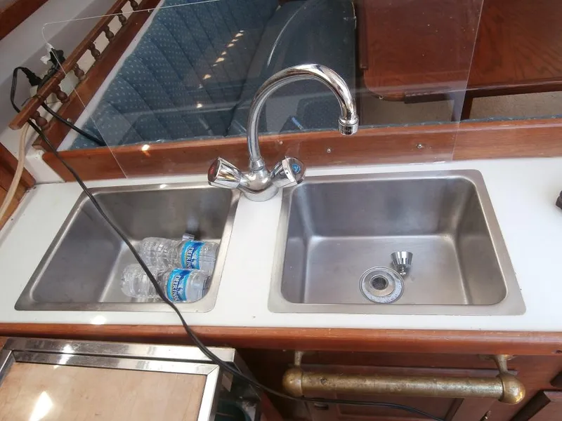 Slide: The Image of 1978 Catalina 30 yacht kitchen sink with dual basins and chrome faucet. - 21