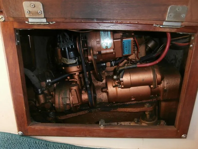 Slide: The Image of Engine compartment of a 1978 Catalina 30 sailboat, showcasing mechanical components and wiring. - 24