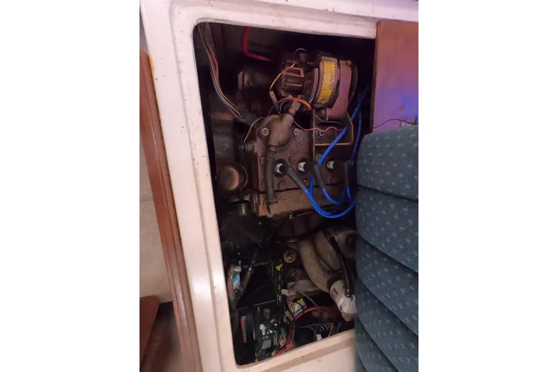 Slide: The Image of Engine compartment of a 1978 Catalina 30 sailboat with visible wiring and components. - 25