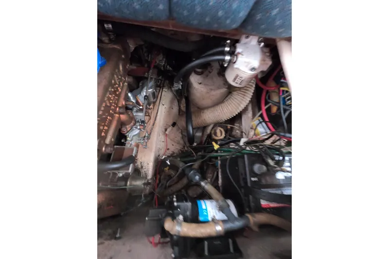 Slide: The Image of Engine compartment of a 1978 Catalina 30 sailboat, showing wiring and mechanical components. - 26