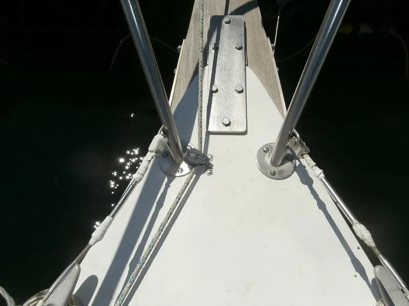 Slide: The Image of Bow of 1978 Catalina 30 sailboat with metal fittings and sunlight reflections on water. - 3