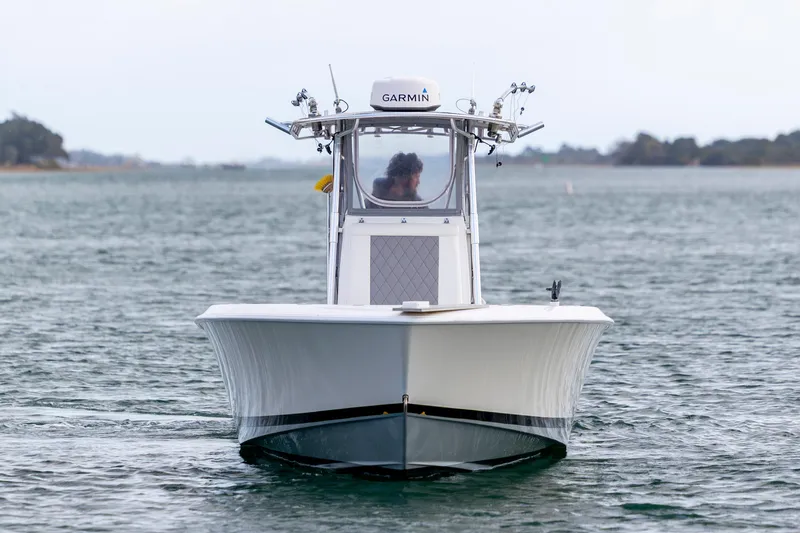 Slide: The Image of 2013 Contender 32 Tournament boat on water, front view, equipped with Garmin technology. - 1