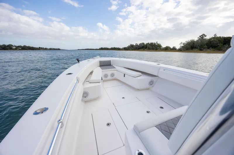 Slide: The Image of 2013 Contender 32 Tournament boat on calm waters, featuring spacious deck and seating. - 12