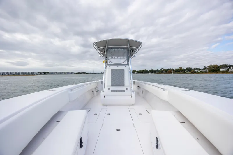 Slide: The Image of 2013 Contender 32 Tournament boat on water under cloudy sky. - 15