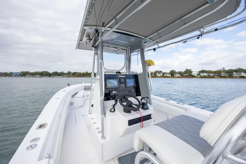 Slide: The Image of 2013 Contender 32 Tournament boat interior with steering console on calm water. - 18