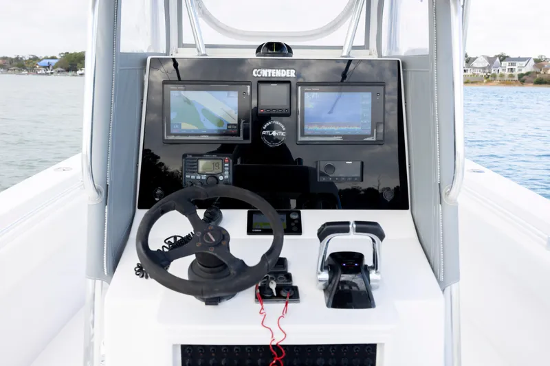 Slide: The Image of 2013 Contender 32 Tournament boat dashboard with navigation screens and steering wheel. - 20