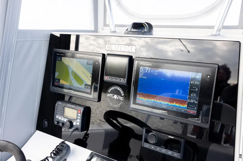 Slide: The Image of Dashboard of a 2013 Contender 32 Tournament boat with navigation and sonar displays. - 21