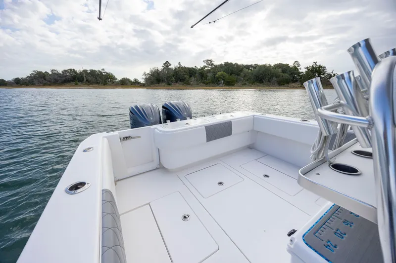 Slide: The Image of 2013 Contender 32 Tournament boat with dual engines on calm water. - 23
