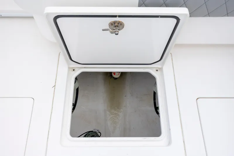 Slide: The Image of Open hatch on 2013 Contender 32 Tournament boat, revealing storage compartment. - 27