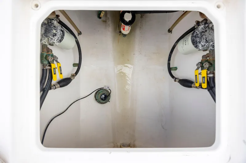 Slide: The Image of Bilge area of a 2013 Contender 32 Tournament boat, showing pumps and hoses. - 28