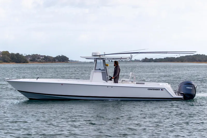 Slide: The Image of 2013 Contender 32 Tournament boat on water, side view, with Yamaha engine. - 3