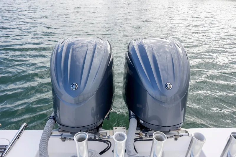 Slide: The Image of Twin Yamaha outboard motors on a 2013 Contender 32 Tournament boat in water. - 31