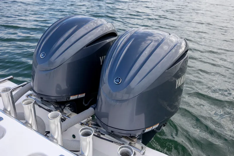 Slide: The Image of Twin Yamaha outboard engines on a 2013 Contender 32 Tournament boat in water. - 32