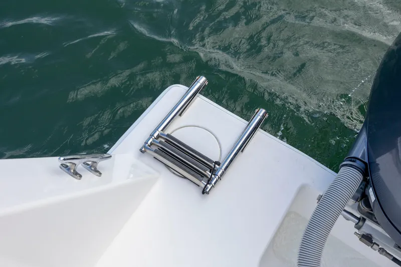 Slide: The Image of 2013 Contender 32 Tournament boat with stainless steel ladder and cleat by the water. - 33