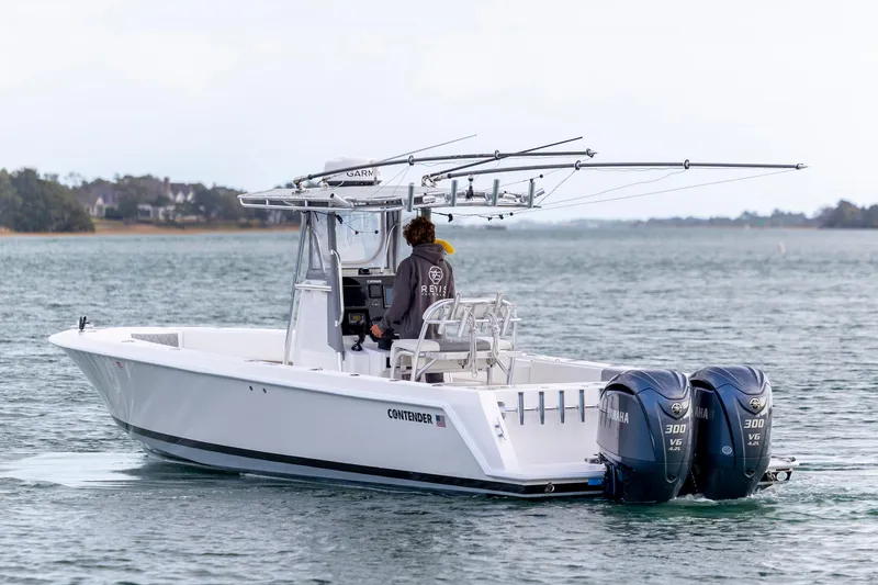 Slide: The Image of 2013 Contender 32 Tournament boat with dual Yamaha engines on open water. - 5