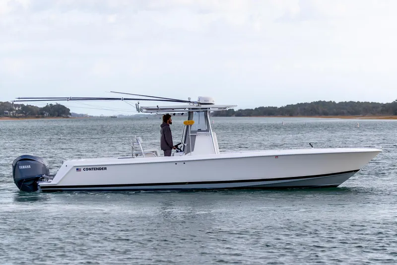 Slide: The Image of 2013 Contender 32 Tournament boat on water, side view, with Yamaha engine. - 9