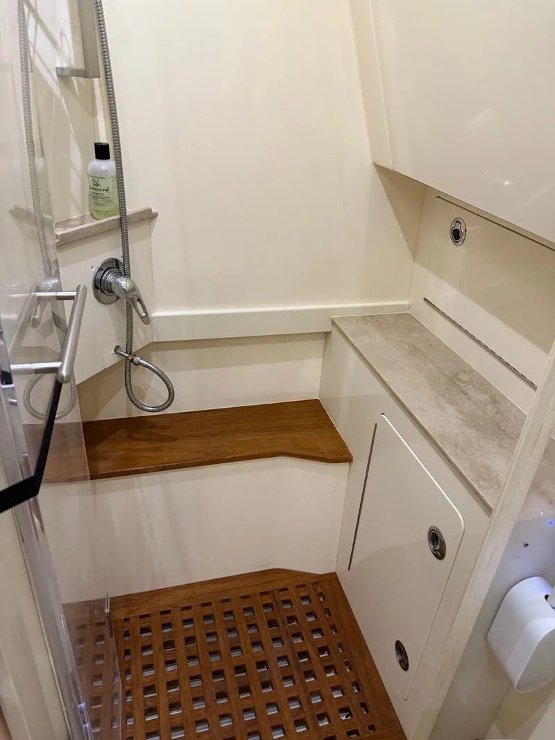 Slide: The Image of Luxurious shower area in 2016 Scout 42LXF boat with wooden accents and modern fixtures. - 1