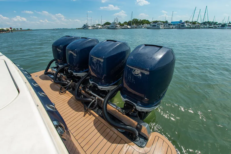 Slide: The Image of Four outboard engines on a boat in a harbor. - 14