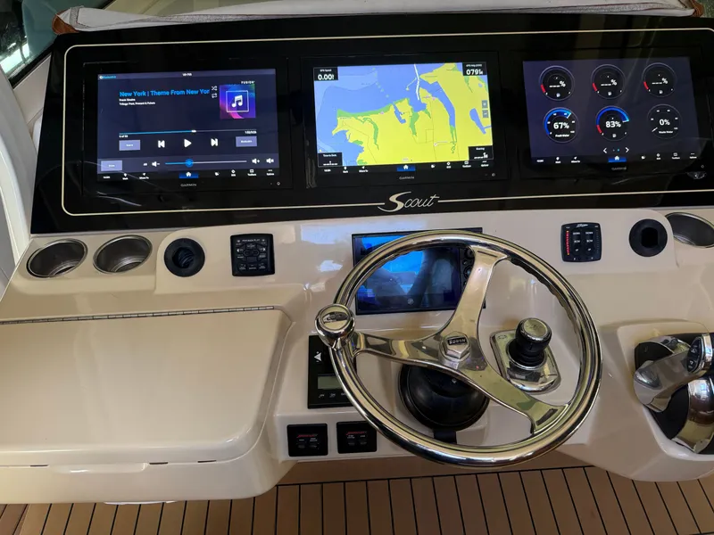 Slide: The Image of Control panel of a 2016 Scout 42LXF boat with navigation and audio displays. - 2