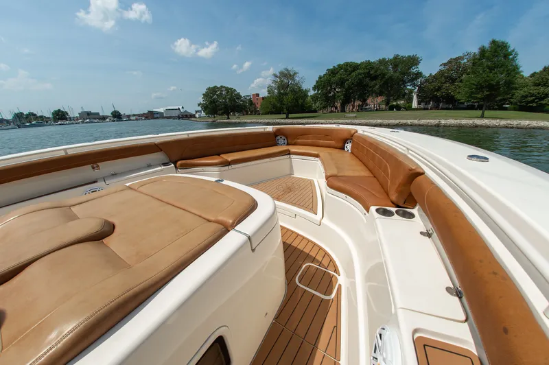 Slide: The Image of 2016 Scout 42LXF with luxurious deck and leather seating on calm water. - 20