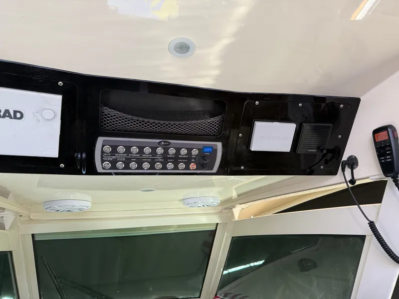 Slide: The Image of 2016 Scout 42LXF boat dashboard with control panel and communication devices. - 3