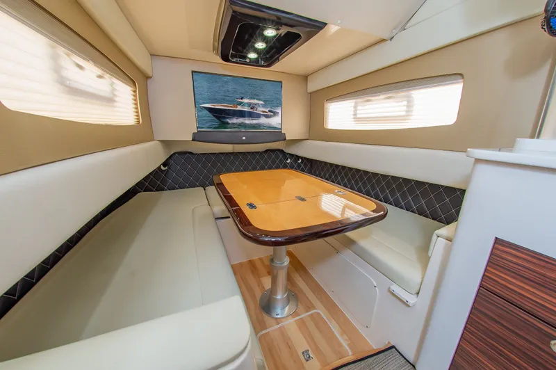 Slide: The Image of Interior of a 2016 Scout 42LXF with an elegant seating area and wooden table. - 30