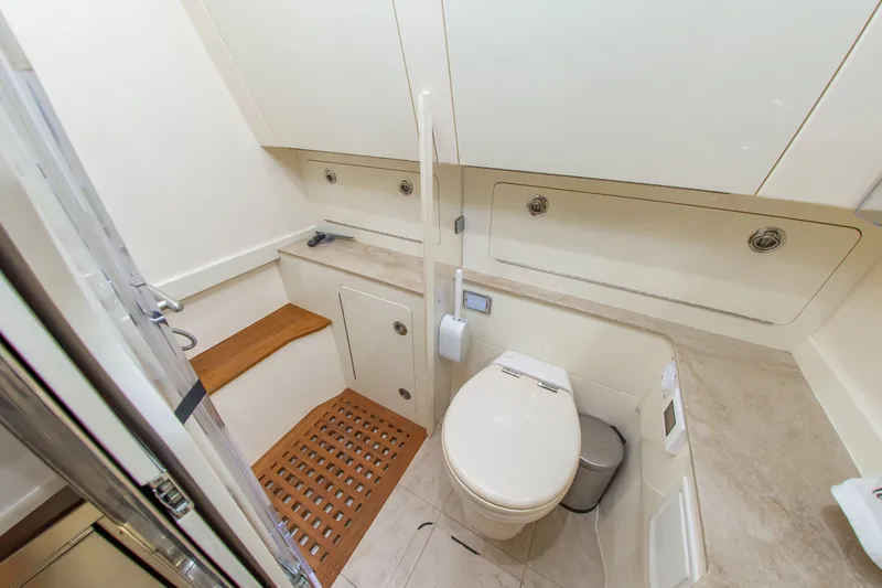 Slide: The Image of Interior view of a boat bathroom with toilet, sink, and wooden accents. - 35