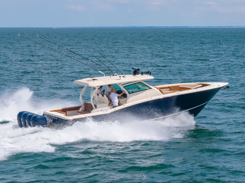 Slide: The Image of A 2016 Scout 42LXF boat speeding across the ocean. - 42