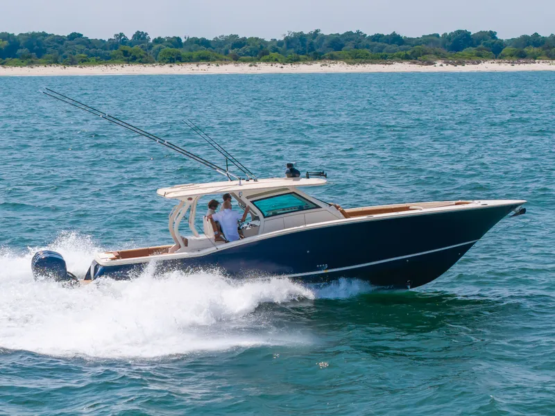 Slide: The Image of 2016 Scout 42LXF on the water, with two people aboard, speeding over the waves. - 44