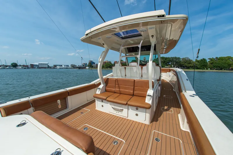 Slide: The Image of 2016 Scout 42LXF on calm water with spacious deck and comfortable seating. - 8
