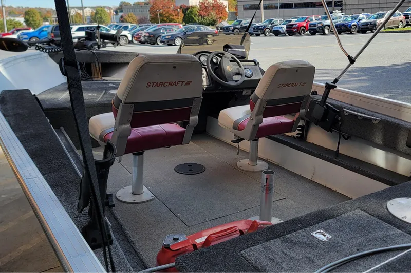 Slide: The Image of 1999 Starcraft Starfire 160 SC boat interior with two seats and steering console. - 5