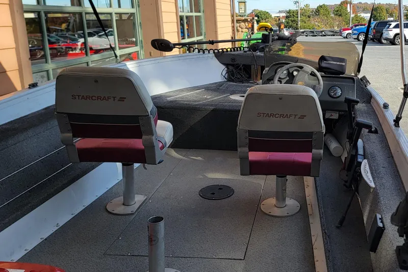 Slide: The Image of 1999 Starcraft Starfire 160 SC boat interior with dual seats and steering console. - 6