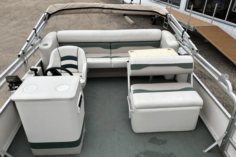 Slide: The Image of 2003 Smoker Craft Oasis pontoon boat interior with seating and steering console. - 10