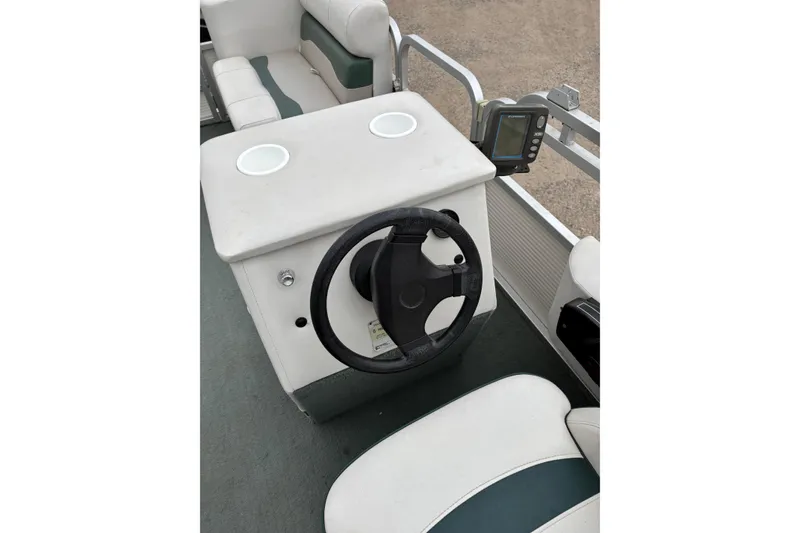 Slide: The Image of 2003 Smoker Craft Oasis boat interior with steering wheel and seating. - 12