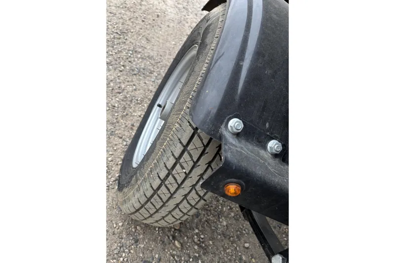 Slide: The Image of Close-up of a 2003 Smoker Craft Oasis trailer tire on gravel. - 8