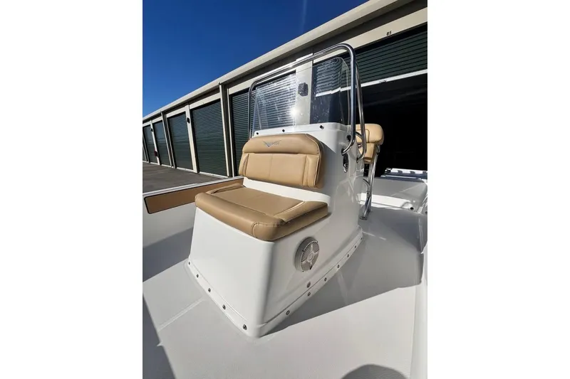 Slide: The Image of 2025 Savannah 190 IS boat with tan seating and sleek design in storage facility. - 14