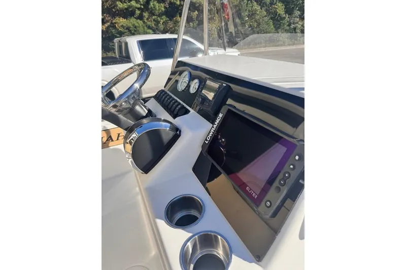 Slide: The Image of 2025 Savannah 190 IS boat dashboard with steering wheel, gauges, and Lowrance Elite display. - 5