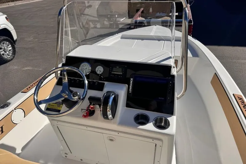 Slide: The Image of 2025 Savannah 190 IS boat dashboard with steering wheel and navigation instruments. - 6