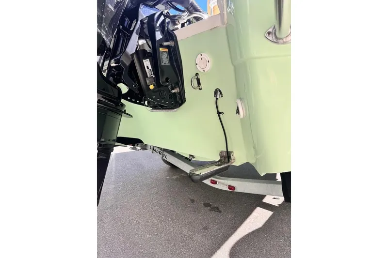 Slide: The Image of Rear view of 2025 Savannah 190 IS boat, showcasing engine and trailer details. - 9