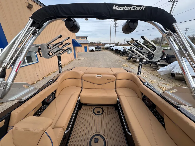 Slide: The Image of Interior of a 2021 MasterCraft XT23 boat with beige seating. - 10