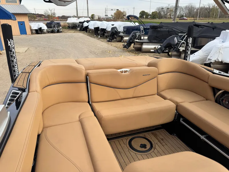 Slide: The Image of Interior of a 2021 MasterCraft XT23 with beige leather seating. - 12