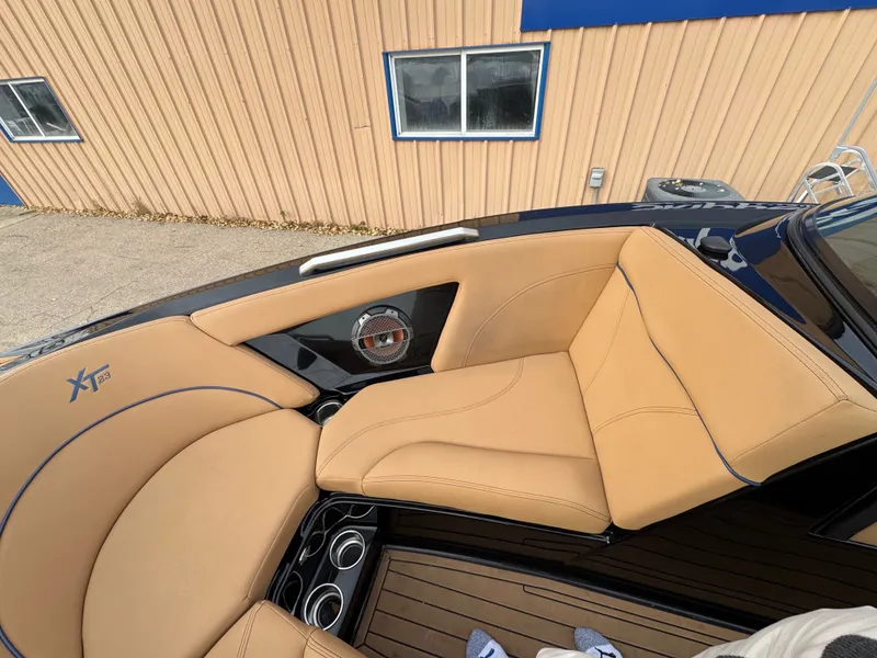 Slide: The Image of Interior of a 2021 MasterCraft XT23 boat with beige seating. - 14